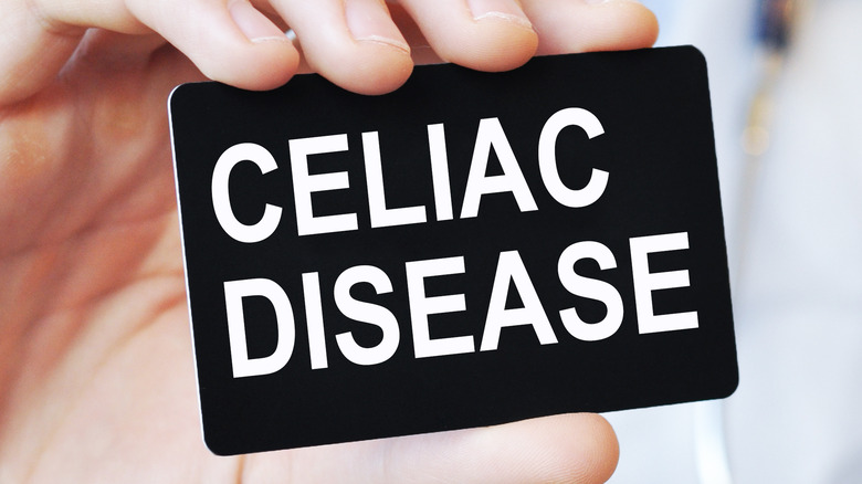 Doctor holding a black paper card with text CELIAC DISEASE