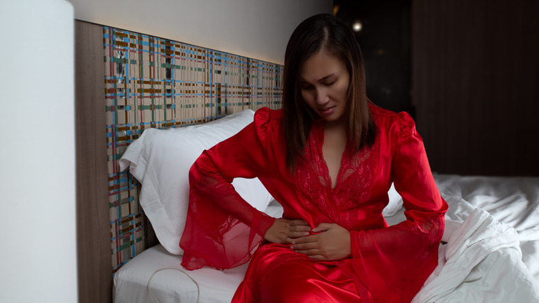 woman wearing red robe sitting