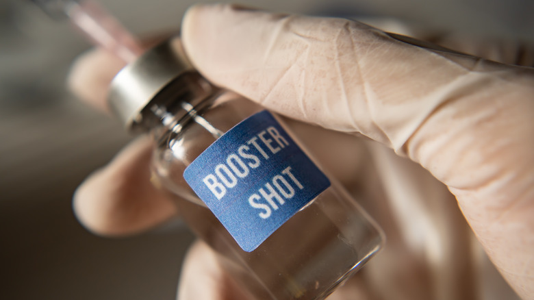 Small vaccine vial labeled "booster shot"