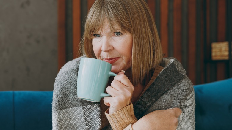 sick elderly woman drinking milk