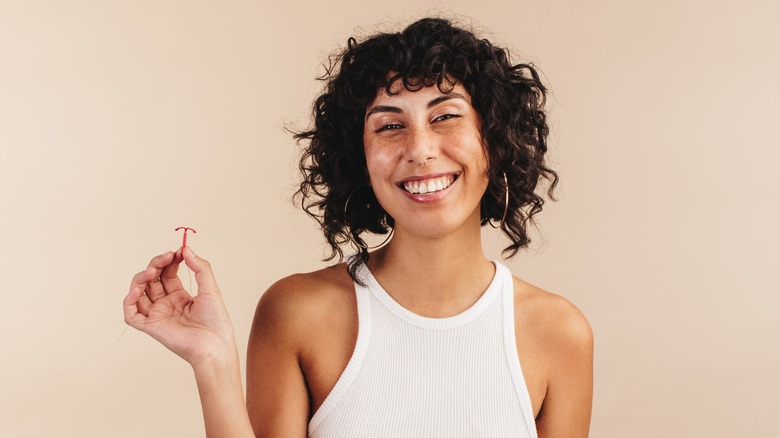 Young woman holding an IUD