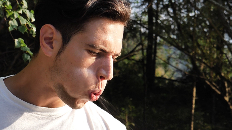A man spitting on the ground