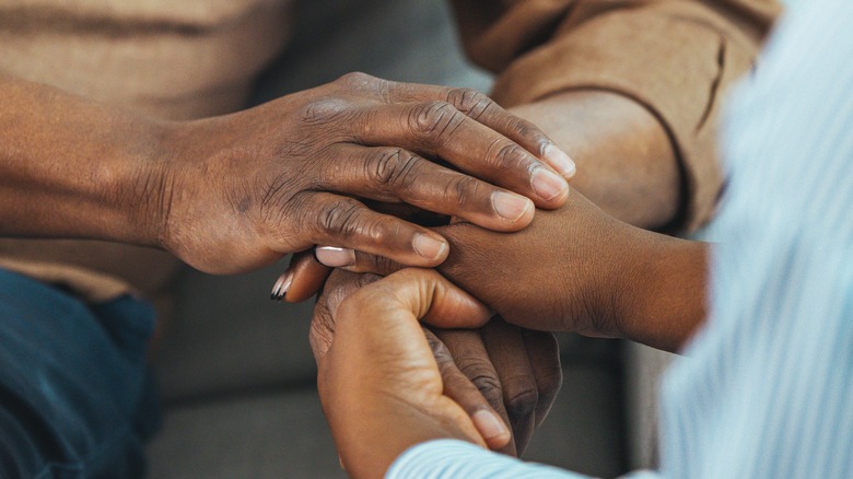 Two people holding hands