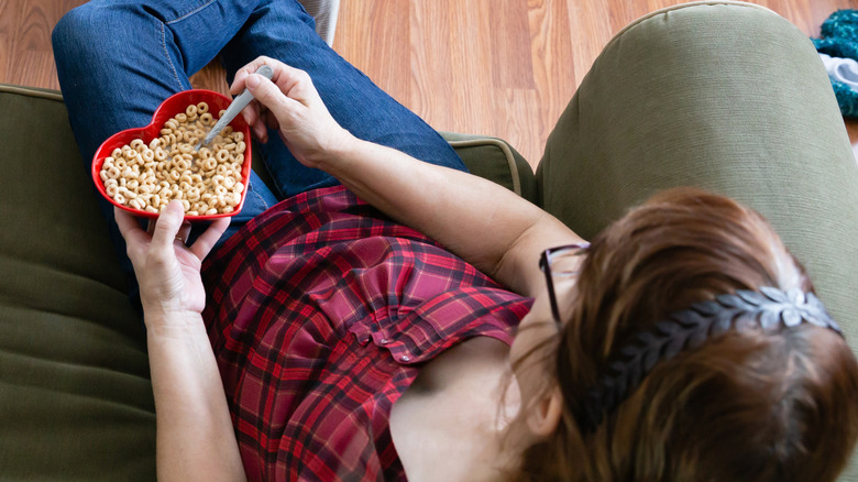 woman eating cheerios in heart-shaped bowl