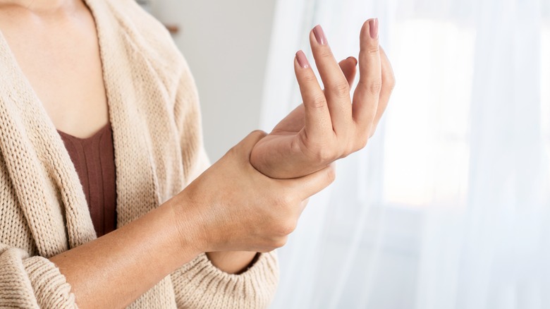 woman holding her wrists