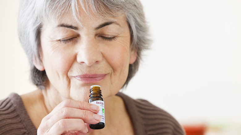 woman smelling essential oil