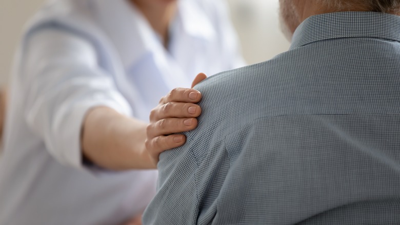 Doctor touching patient's shoulder