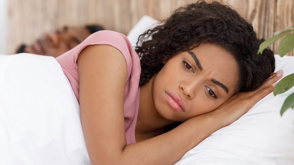 Unhappy woman in bed
