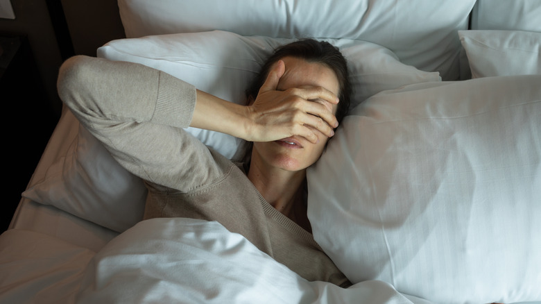 A woman lying in bed unable to sleep