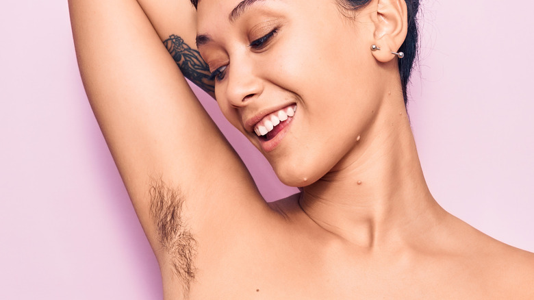 Happy woman with underarm hair