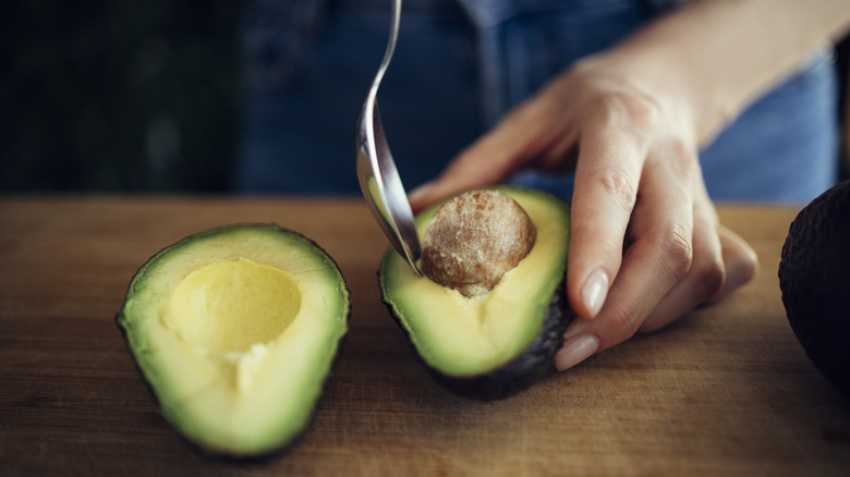 Spooning avocado flesh