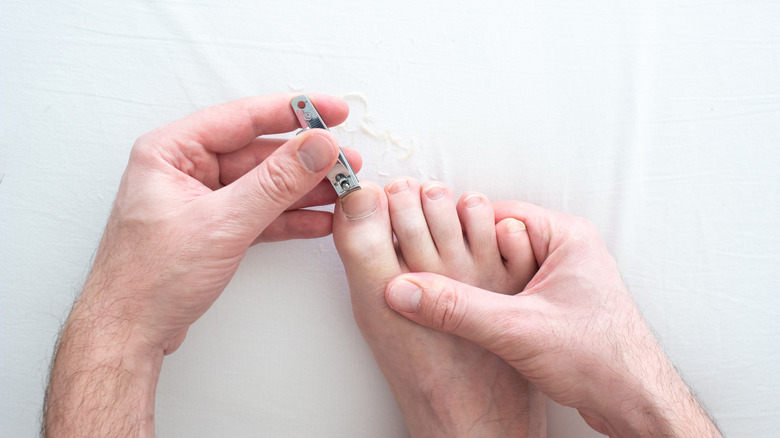 Close up of man clipping his toenails
