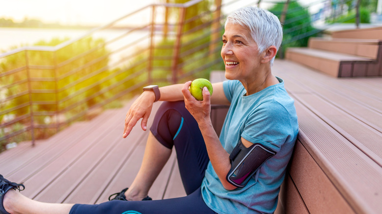 Woman eating a green apple