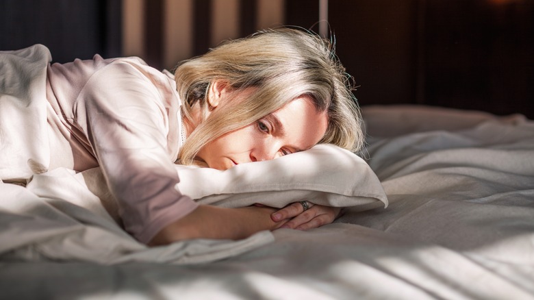 Woman lying in bed and unable to sleep