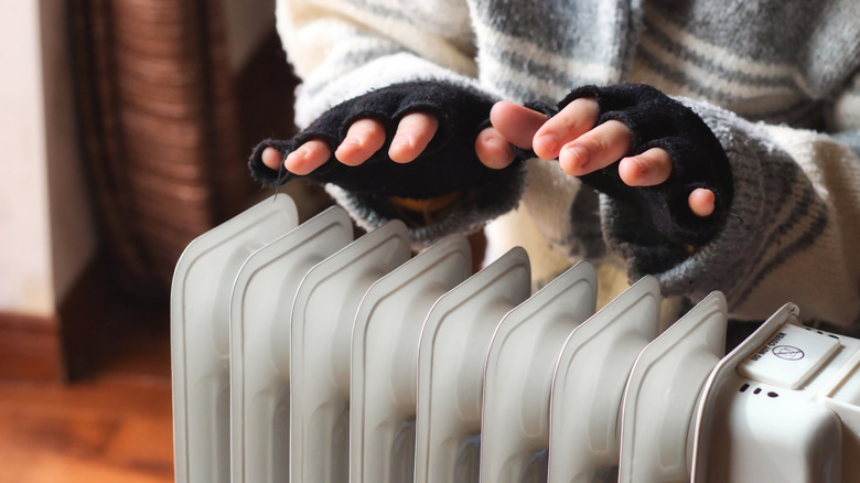 Gloved hands over heating unit