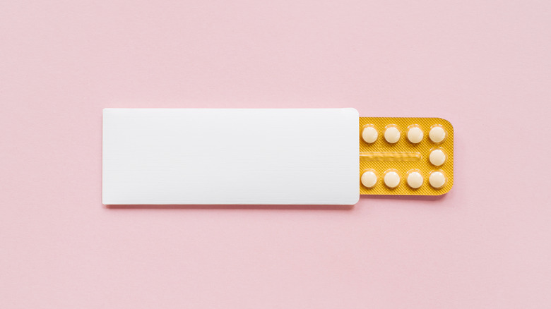 Birth control pills on pink background