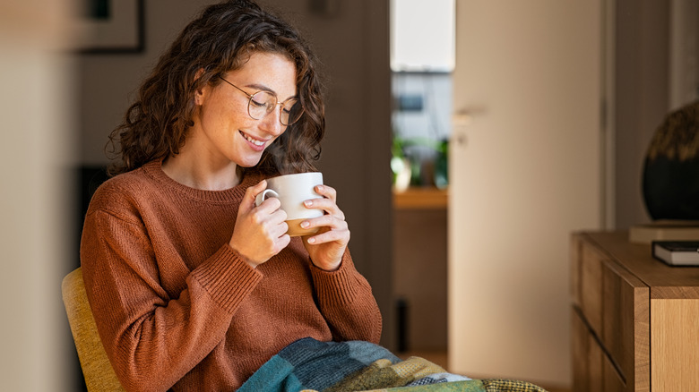 Happy woman drinking tea
