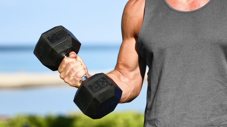 Man performing arm exercise outdoors