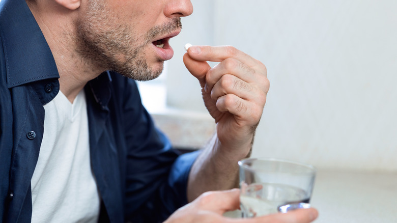 man taking medicine