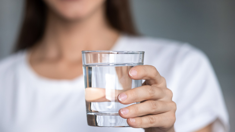 Female holding glass of water