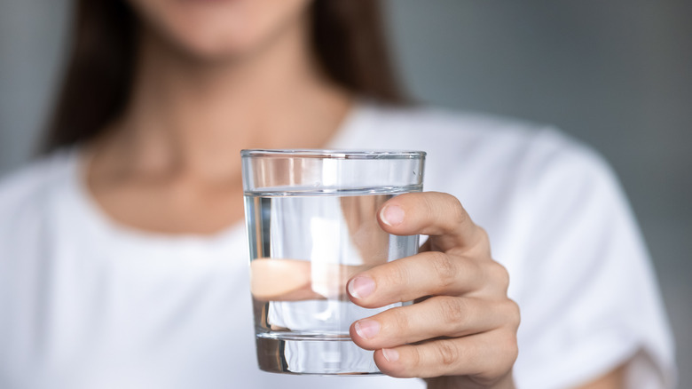 Female holding glass of water