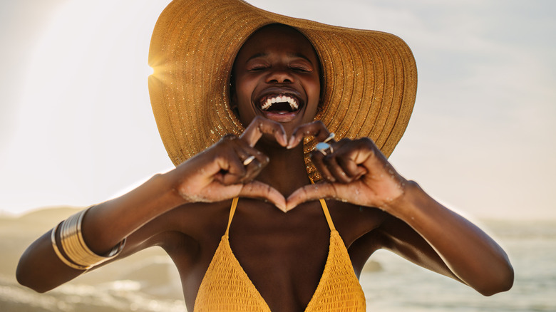 Woman making heart gesture