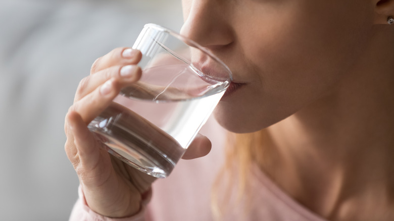 Woman drinking from water glass