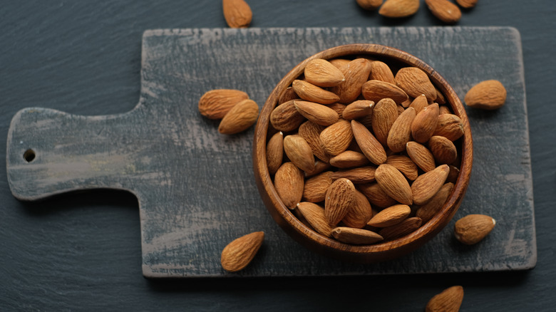 bowl of almonds on a cutting board