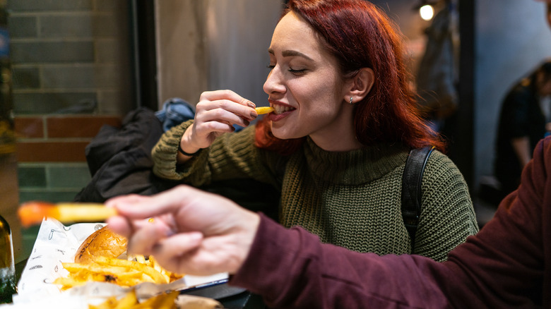 woman eating french fries