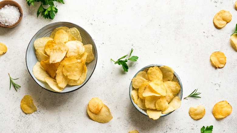 guilty woman eating potato chips 