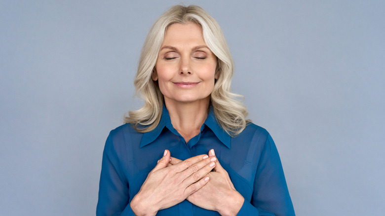 calm woman holding chest