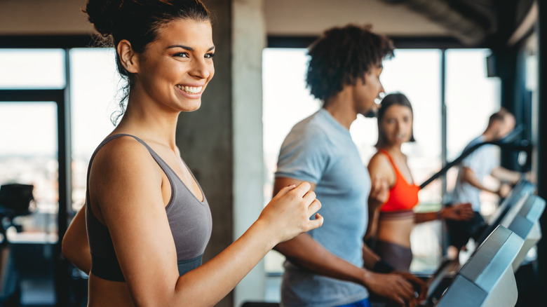 Fit people using the treadmills in a gym