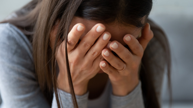 woman stressed out with head in heads