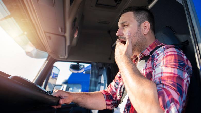 Truck driver yawning while driving 