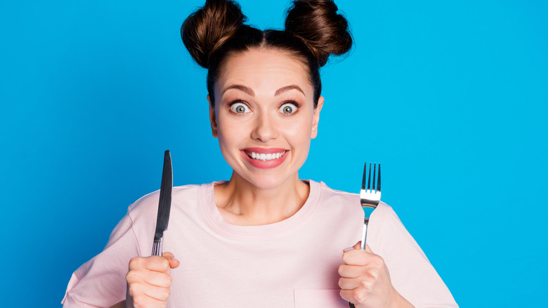 Woman holding fork and knife