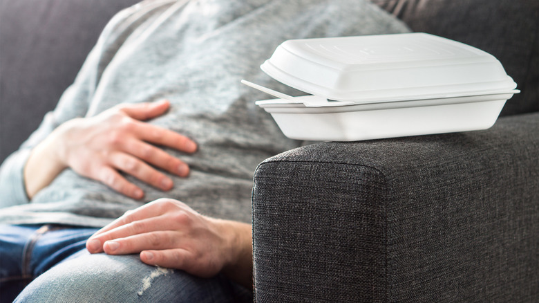 Person on couch with stomach pain