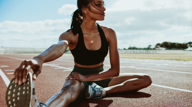 Woman stretching on track