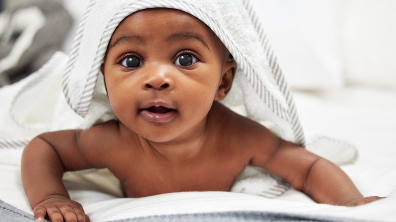 baby boy with blanket over his head