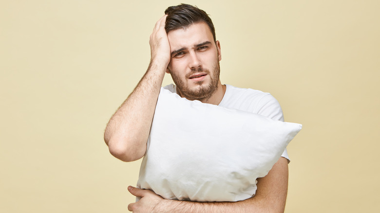 Man holding a pillow