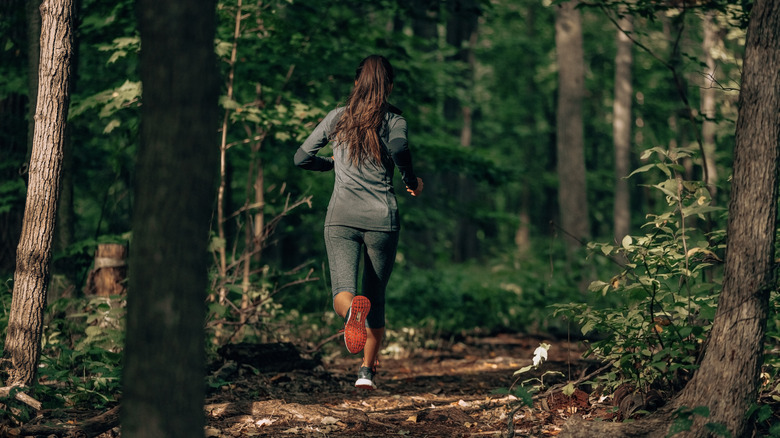 Woman running in the woods
