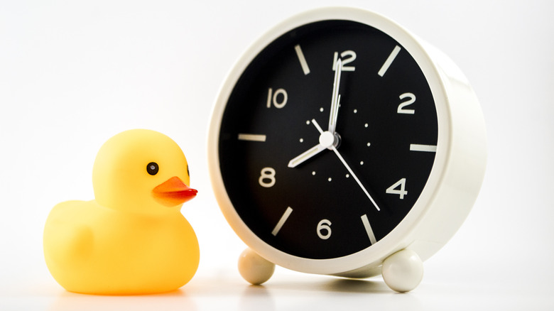 Clock next to rubber duck