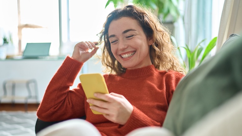 woman on couch with phone