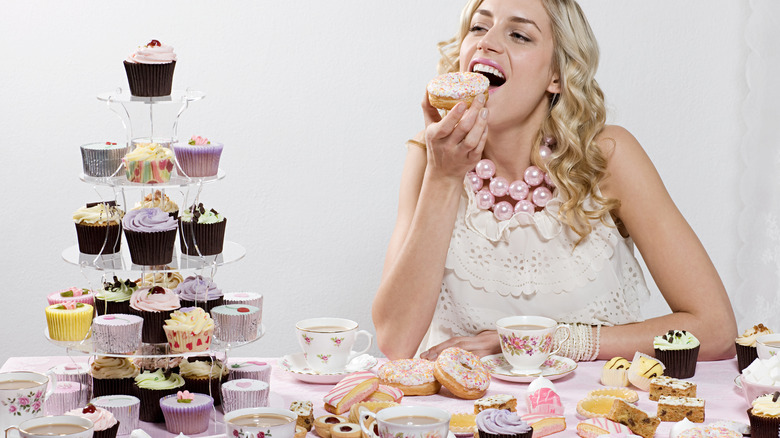 Woman eating pastries