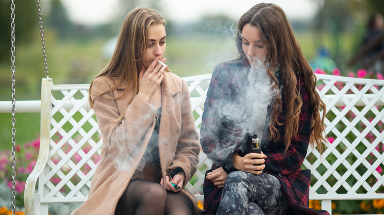 Two women smoking and vaping