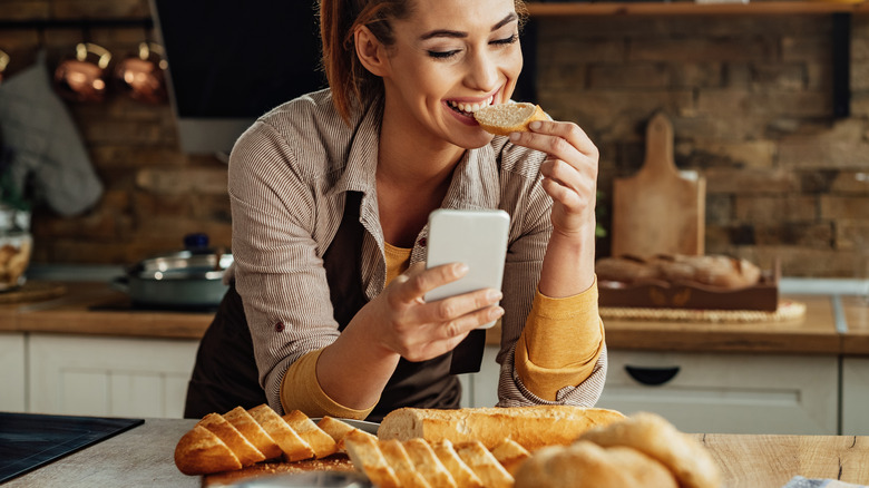 Woman eating bread in the kitchen