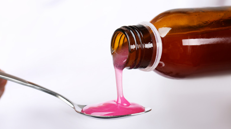 cough medicine pouring onto spoon