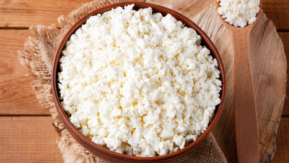 A wooden bowl full of cottage cheese