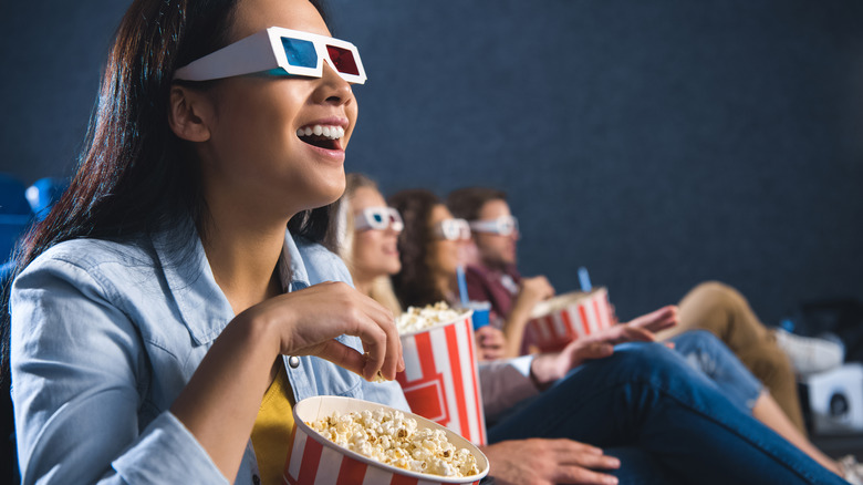 Group of friends wearing 3D glasses in a movie theater