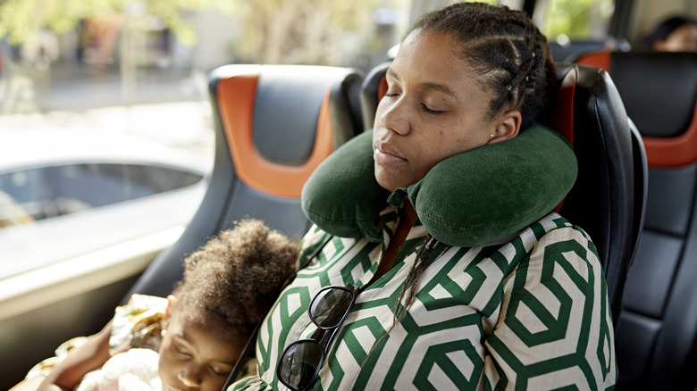 Woman and daughter asleep on bus