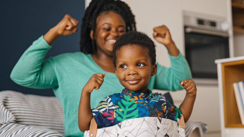 Mom and son flexing arm muscles